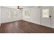Bright living room featuring gleaming hardwood floors, neutral walls, and a door at 209 E 1St N St, Summerville, SC 29483