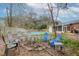 Backyard with a firepit seating area and an in-ground pool surrounded by trees at 214 Terry Ave, Summerville, SC 29485