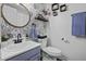 Stylish bathroom with floral wallpaper, a round mirror, and modern fixtures at 214 Terry Ave, Summerville, SC 29485