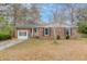 Charming brick home featuring a well-maintained front yard and classic architectural details at 214 Terry Ave, Summerville, SC 29485