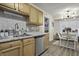 Kitchen with stainless steel appliances, stylish backsplash, and open view to the dining area at 214 Terry Ave, Summerville, SC 29485