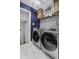 Modern laundry room with patterned accent wall and front loading washer and dryer at 214 Terry Ave, Summerville, SC 29485