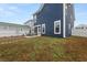 Spacious backyard featuring a patio with an outdoor dining set, with green and brown grass at 219 Symphony Ave, Summerville, SC 29486