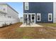 Landscaped backyard featuring a patio with outdoor seating, perfect for relaxing and entertaining guests at 219 Symphony Ave, Summerville, SC 29486