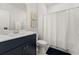Bathroom with vanity, framed mirror, and tub-shower with a white shower curtain at 219 Symphony Ave, Summerville, SC 29486