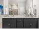 Bathroom featuring dual sinks, granite countertops, dark cabinets and walk-in shower at 219 Symphony Ave, Summerville, SC 29486