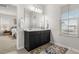 Bright bathroom featuring dual sinks, dark cabinets, and a large mirror at 219 Symphony Ave, Summerville, SC 29486