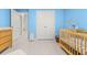 Bright Bedroom with a wooden crib, dresser, and pale blue accent walls at 219 Symphony Ave, Summerville, SC 29486