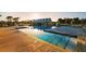 Beautiful pool with palm trees with sun reflecting off of community building at 219 Symphony Ave, Summerville, SC 29486