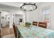 Dining room with wood floors, chandelier and table with decorated table cloth and access to office at 219 Symphony Ave, Summerville, SC 29486