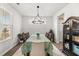 Bright dining room features chandelier, table with decorative tablecloth, and a window providing natural light at 219 Symphony Ave, Summerville, SC 29486