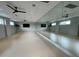 A spacious exercise room with floor to ceiling mirrors and ceiling fans provides a perfect workout space at 219 Symphony Ave, Summerville, SC 29486