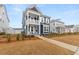 Two-story home with a double porch, white trim and a freshly landscaped yard at 219 Symphony Ave, Summerville, SC 29486