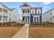 Stunning two-story blue home with double porches and vibrant landscaping at 219 Symphony Ave, Summerville, SC 29486