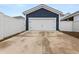 Detached two-car garage with white door, and a concrete driveway at 219 Symphony Ave, Summerville, SC 29486