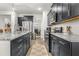 Modern kitchen features granite countertops, stainless steel appliances, and sleek dark cabinetry at 219 Symphony Ave, Summerville, SC 29486