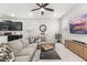 Open-concept living room with kitchen view, modern furnishings, and ample natural light at 219 Symphony Ave, Summerville, SC 29486