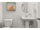 Powder room featuring pedestal sink, round mirror, and toilet at 219 Symphony Ave, Summerville, SC 29486