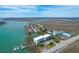 Aerial view of a condo community with boat docks, beach, pool and a scenic coastal waterway at 2395 Folly Road # 4H, Folly Beach, SC 29439