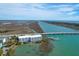 Wide aerial showcasing a modern waterfront condo building with private boat dock, close to the waterway and ocean at 2395 Folly Road # 4H, Folly Beach, SC 29439