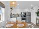 Charming eat-in kitchen with stainless steel appliances, bright white cabinets, and stylish lighting at 2395 Folly Road # 4H, Folly Beach, SC 29439