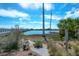 Picturesque waterfront landscape featuring a charming garden, walking path, and a bridge in the background at 2395 Folly Road # 4H, Folly Beach, SC 29439