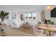 Bright living room featuring white sofas, water views, wood floors, and coastal decor at 2395 Folly Road # 4H, Folly Beach, SC 29439