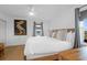 A light and airy main bedroom with a large bed, ceiling fan, and natural light at 2395 Folly Road # 4H, Folly Beach, SC 29439