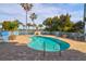 Inviting community pool with a spacious brick patio, surrounded by palm trees at 2395 Folly Road # 4H, Folly Beach, SC 29439