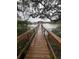 Picturesque wooden dock leading to a gazebo on the water with trees overhead at 2407 Edisto Ferry Rd, Edisto Island, SC 29438