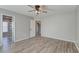 Bedroom with wood-look flooring with adjoining walk-in closet and hall access at 242 Two Pond Loop, Ladson, SC 29456