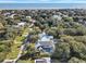 Expansive aerial view of a beautiful home with a pool, surrounded by lush trees and the ocean in the background at 27 22Nd Ave, Isle of Palms, SC 29451