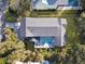 Aerial shot of a house with a private pool and deck surrounded by trees at 27 22Nd Ave, Isle of Palms, SC 29451