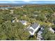 Aerial view capturing a home with a pool and deck area, encircled by green foliage, offering a secluded oasis at 27 22Nd Ave, Isle of Palms, SC 29451