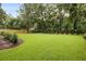 Lush backyard with a manicured lawn and tasteful landscaping at 27 22Nd Ave, Isle of Palms, SC 29451