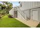 Well manicured lawn with white stair case to the deck above at 27 22Nd Ave, Isle of Palms, SC 29451