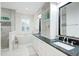 Bright bathroom featuring a soaking tub, shower with decorative tile, and double vanity with black countertops at 27 22Nd Ave, Isle of Palms, SC 29451