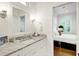 Bathroom boasts a gray countertop, white cabinets, modern fixtures, and an entrance to the bedroom at 27 22Nd Ave, Isle of Palms, SC 29451