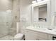 Bright bathroom features white cabinets, framed mirror, and glass shower at 27 22Nd Ave, Isle of Palms, SC 29451