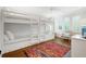 Bedroom featuring built-in bunkbeds, hardwood floors, and bright natural light at 27 22Nd Ave, Isle of Palms, SC 29451