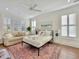 Bright bedroom features a large window, a TV, a ceiling fan, and a decorative rug at 27 22Nd Ave, Isle of Palms, SC 29451