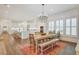 Elegant dining area featuring a stylish chandelier, plantation shutters, and seamless access to the adjacent kitchen at 27 22Nd Ave, Isle of Palms, SC 29451