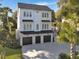 Beautiful three-story home with a three-car garage and a well-maintained lawn at 27 22Nd Ave, Isle of Palms, SC 29451
