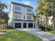 Charming three-story house with a three-car garage and a well-manicured lawn at 27 22Nd Ave, Isle of Palms, SC 29451