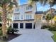 Charming two-story white home featuring a three-car garage and well-manicured landscaping at 27 22Nd Ave, Isle of Palms, SC 29451
