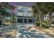 Charming three-story home featuring a three-car garage, set against a colorful sky at 27 22Nd Ave, Isle of Palms, SC 29451