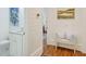 Hallway with wood floors and white shiplap walls, featuring an adjacent bathroom and bedroom view at 27 22Nd Ave, Isle of Palms, SC 29451