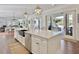 Bright, open kitchen with an expansive island, stainless steel appliances, and direct access to the outdoor pool area at 27 22Nd Ave, Isle of Palms, SC 29451