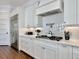 Modern kitchen with stainless steel appliances, white cabinetry, and a stylish herringbone backsplash at 27 22Nd Ave, Isle of Palms, SC 29451