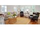 Bright living room features a striped couch, stylish chairs, and a decorative gold coffee table at 27 22Nd Ave, Isle of Palms, SC 29451